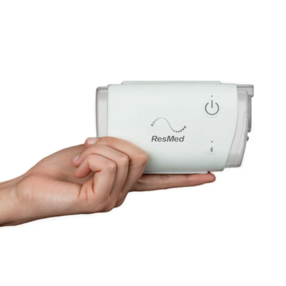 Hand holding the ResMed AirMini AutoSet