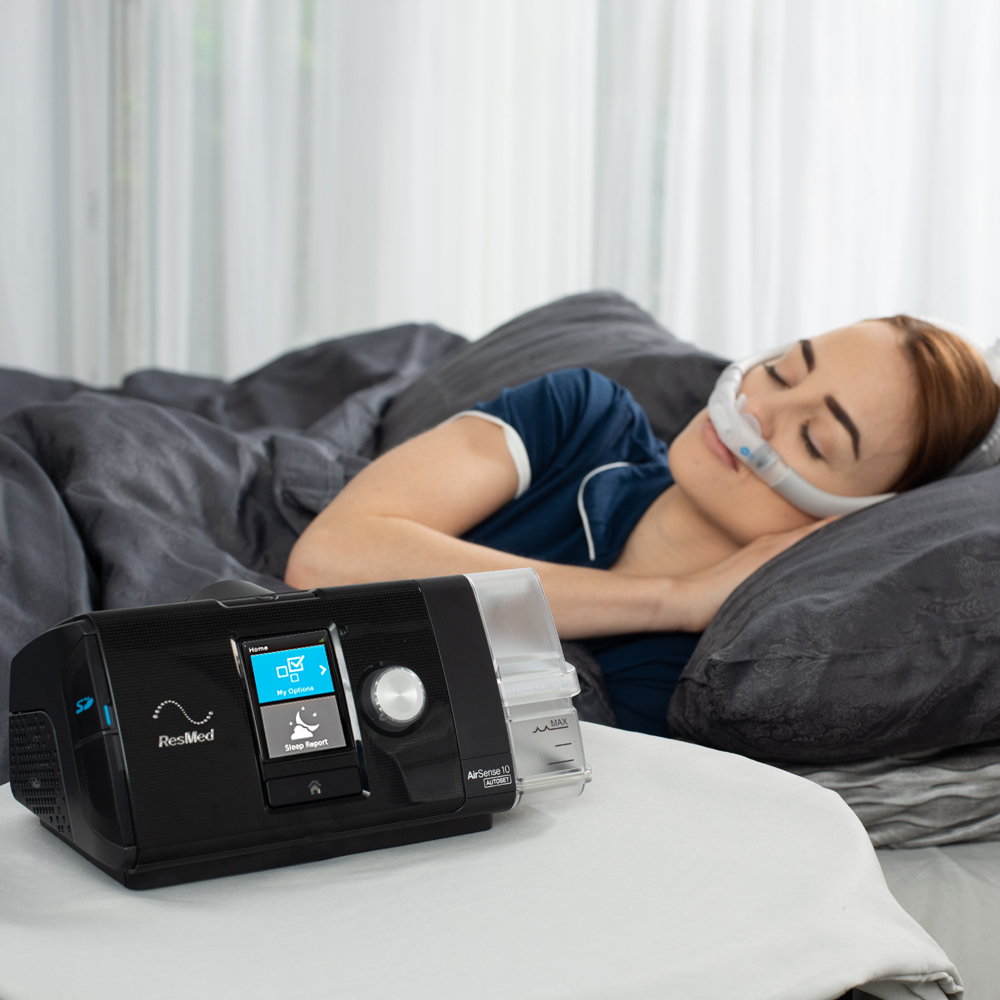 Woman sleeping peacefully with the ResMed AirSense 10 AutoSet CPAP machine