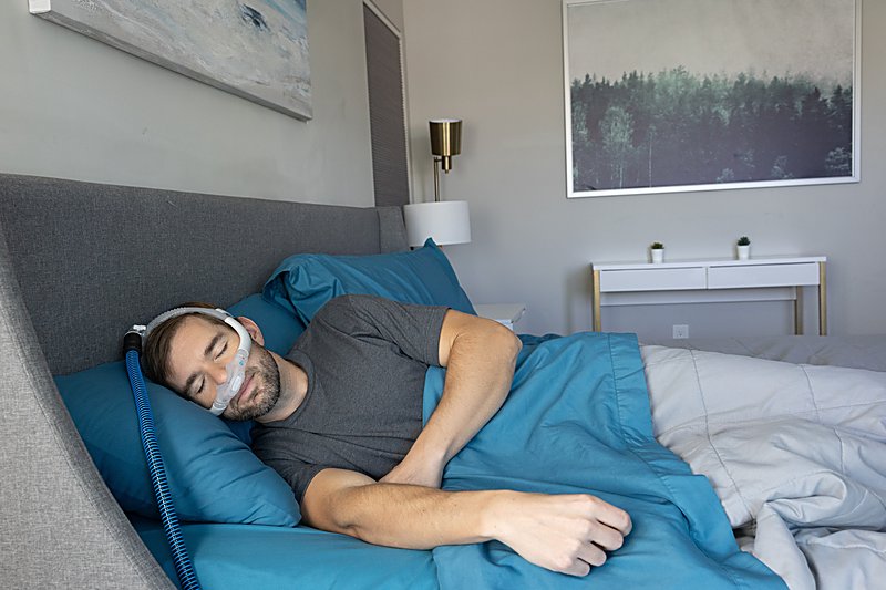 Person sleeping comfortably with a CPAP nasal mask