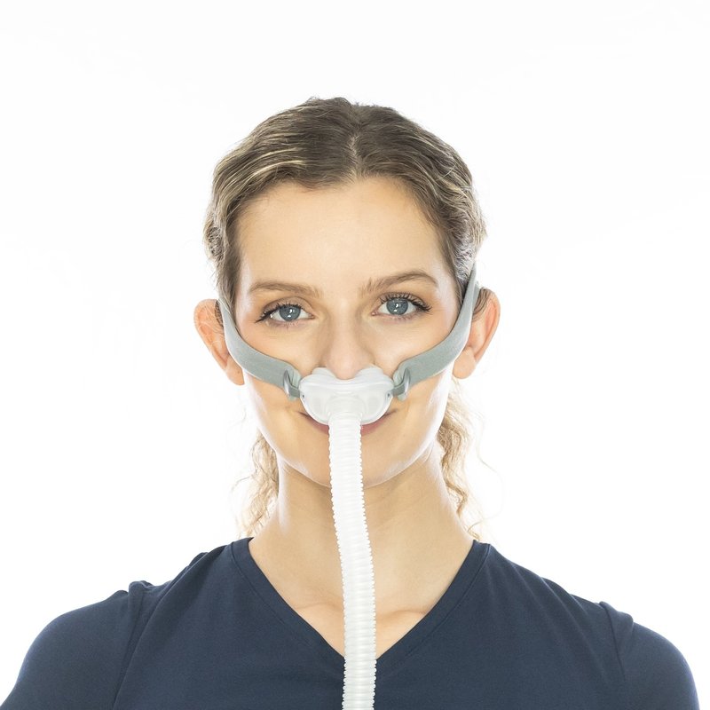 Woman wearing nasal pillow mask